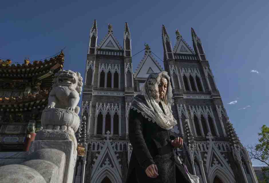 A Christian worshipper leaves a Sunday mass at the Xishiku Catholic Cathedral in Beijing (Kevin Frayer/Getty Images) <br />