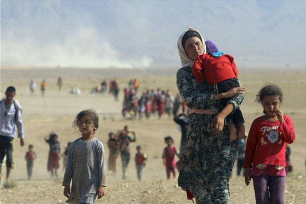 La famiglia yazida in fuga dall'Iraq settenrionale, nel 2014 - Reuters