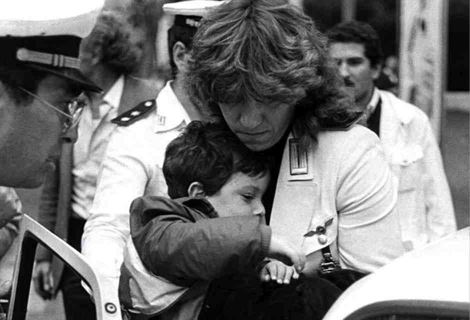 Jonathan Pacifici, uno dei bambini feriti nell'attentato alla sinagoga, tra le braccia di una vigilessa (foto Ansa/Massimo Capodanno)